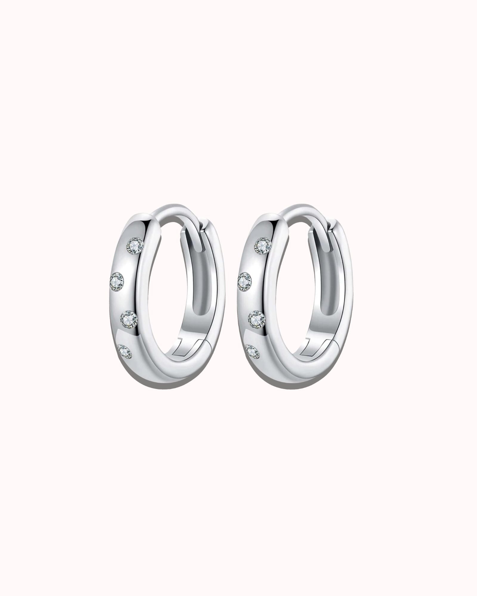Moissanite huggie hoops in white gold