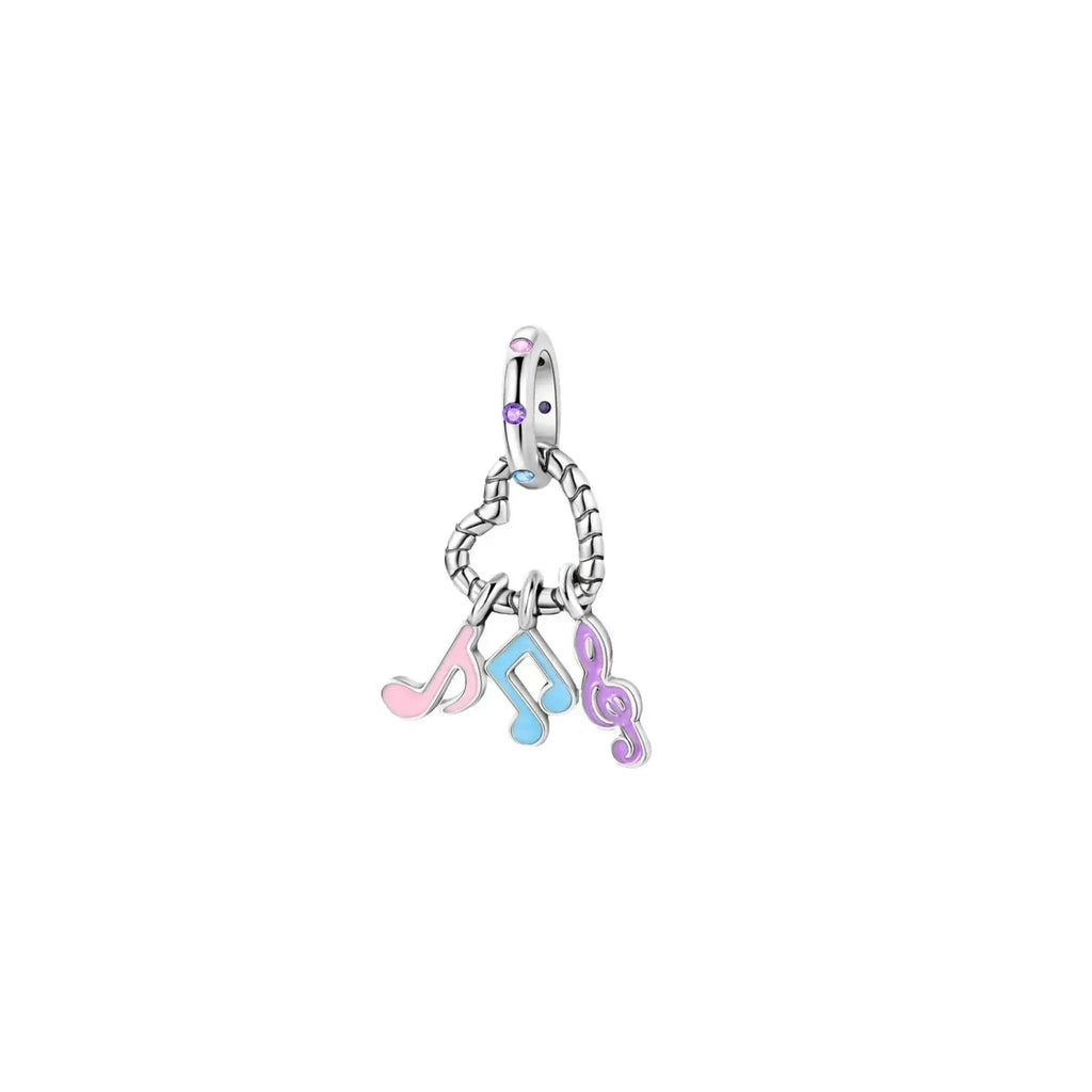 Silver charm with musical note symbols on a white background