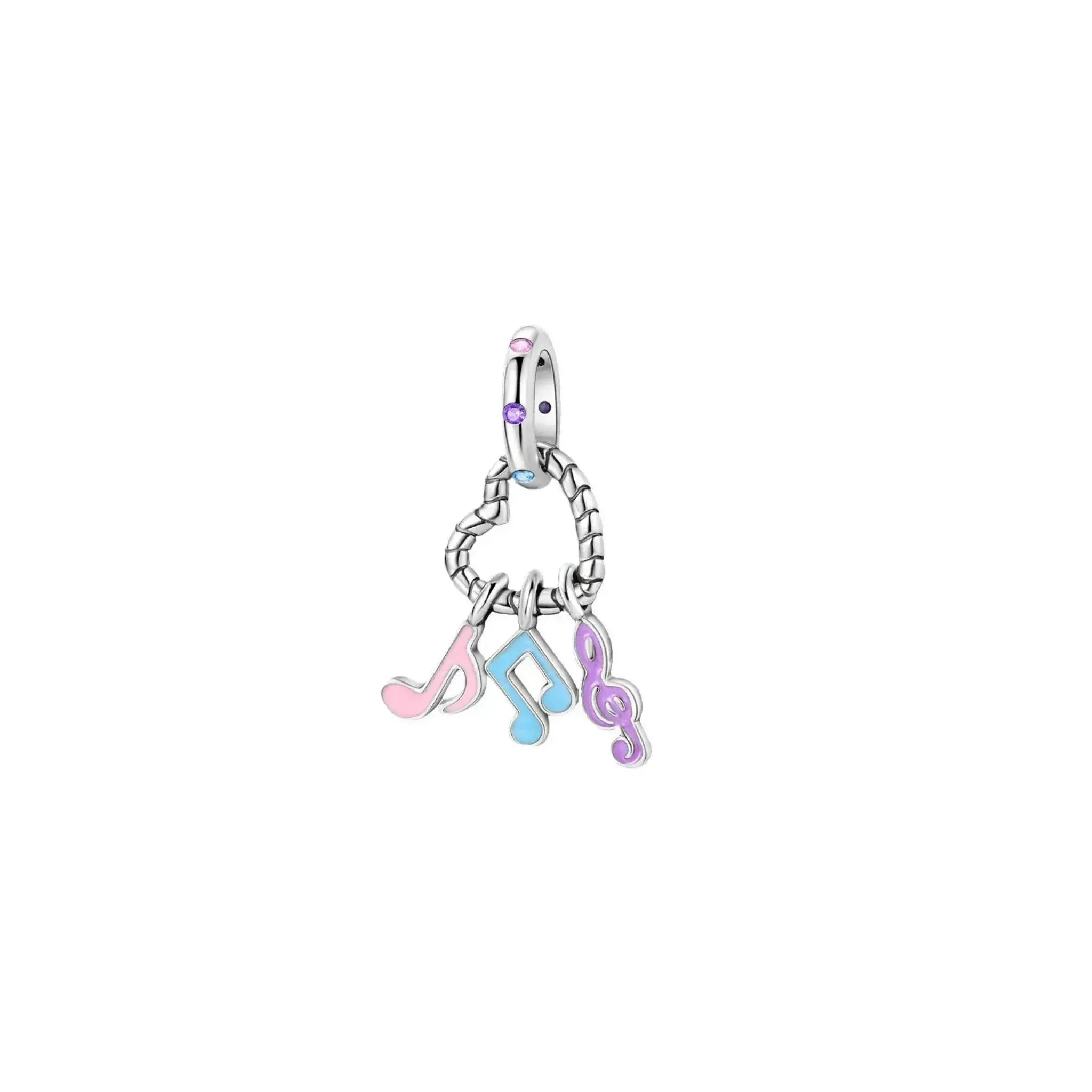 Silver charm with musical note symbols on a white background
