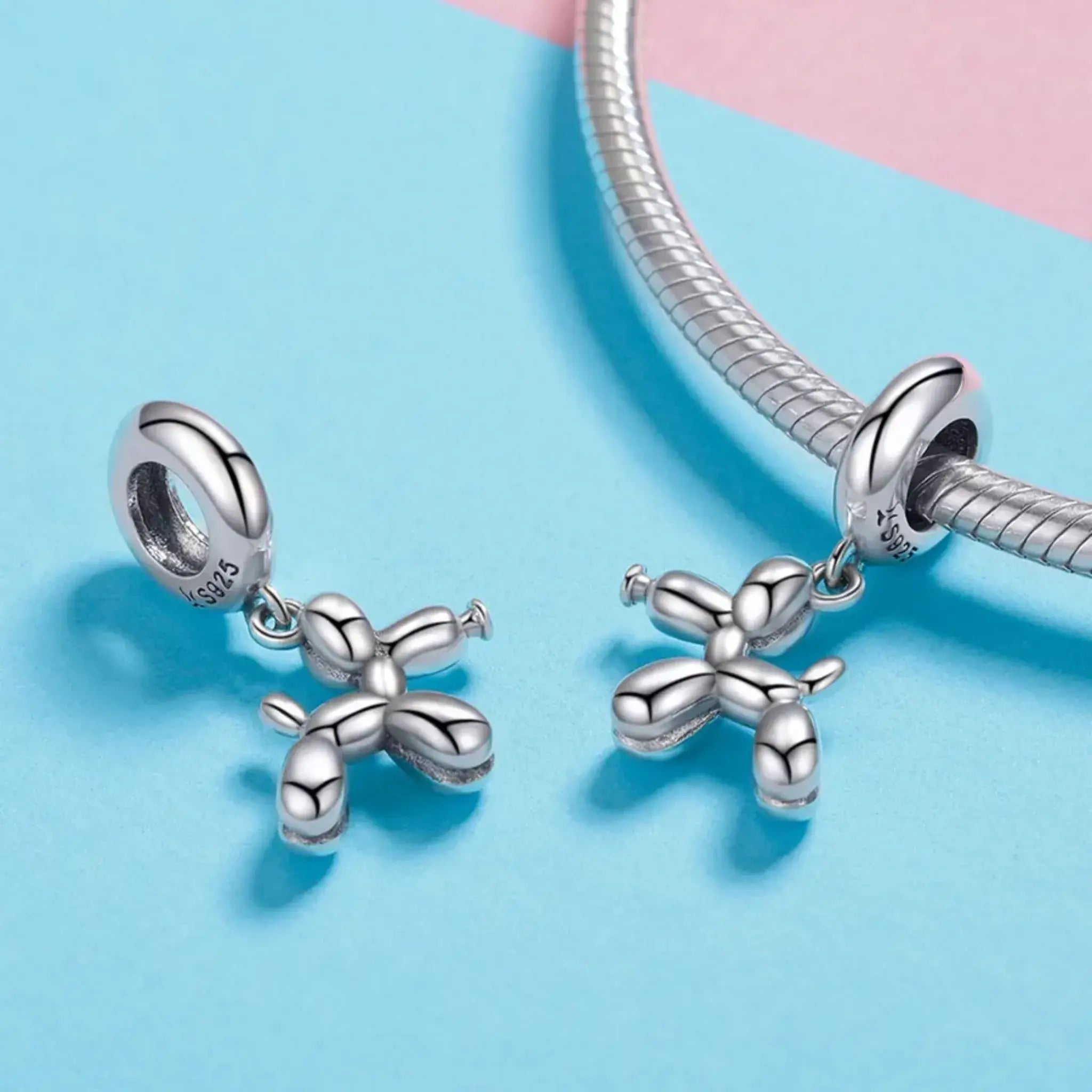 Silver balloon charm on a blue background