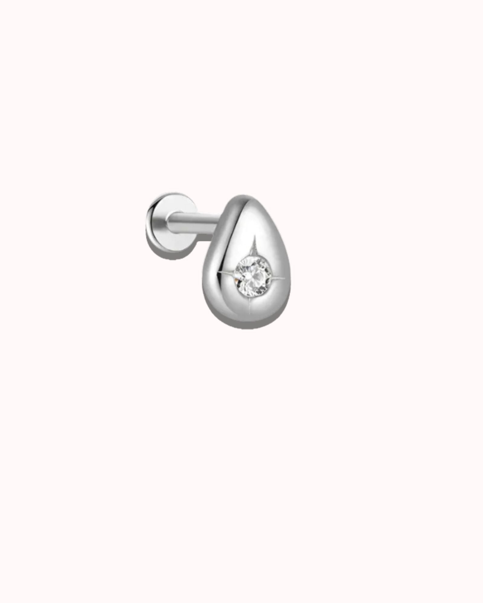 Silver earring with a small diamond on a white background