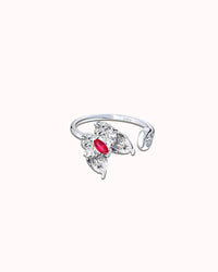 Silver ring with a red gemstone on a white background