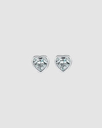 Heart-shaped diamond stud earrings on a light gray background