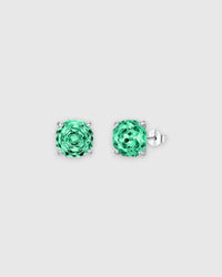 Pair of green stud earrings on a light gray background