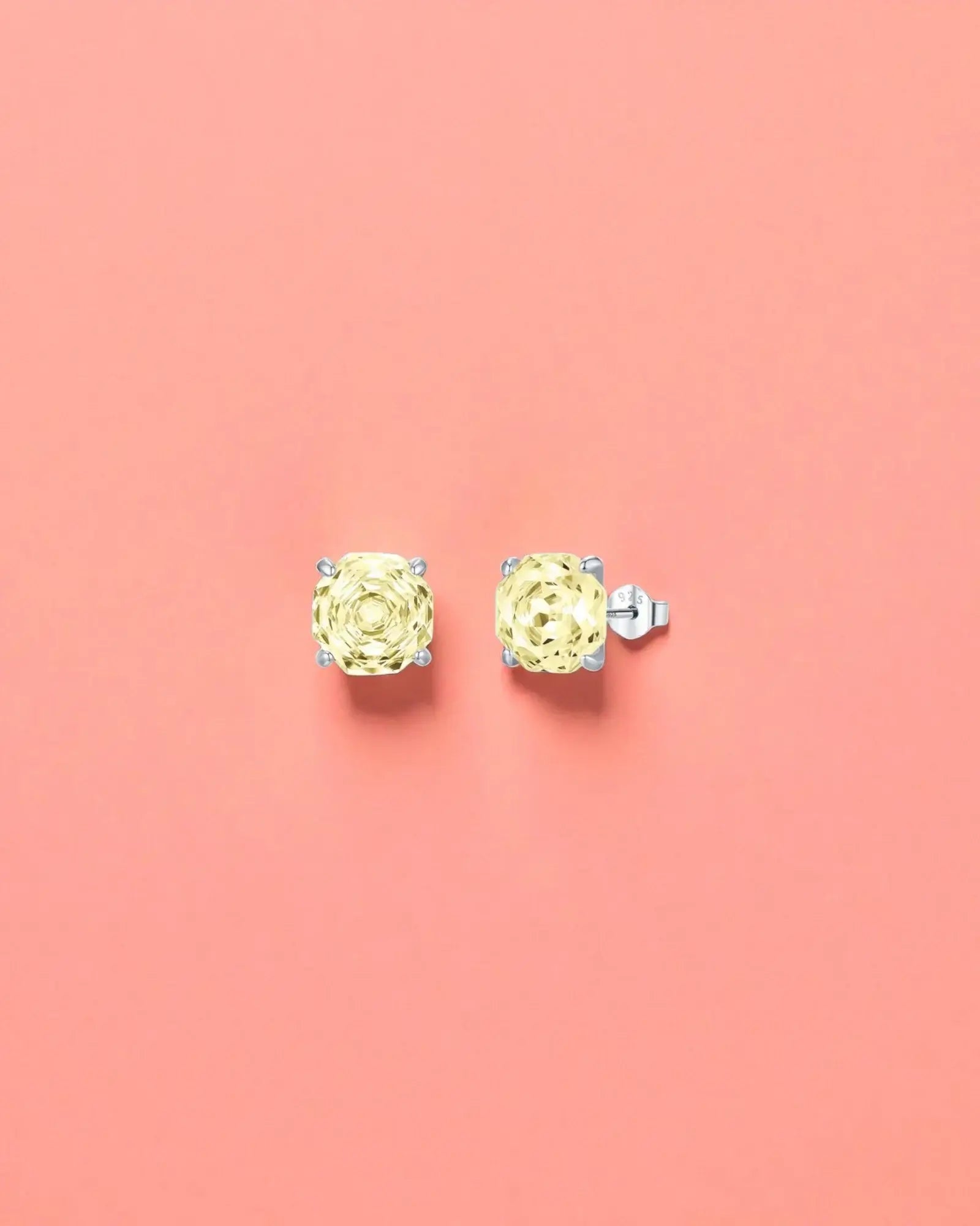 Octagonal Rose Cut Yellow Zircon Stud in Silver on a pink background, showcasing the elegant design and sparkling details.