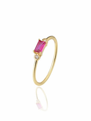 Elegant gold ring featuring a vibrant pink stone, perfect for adding a touch of sophistication to any outfit.