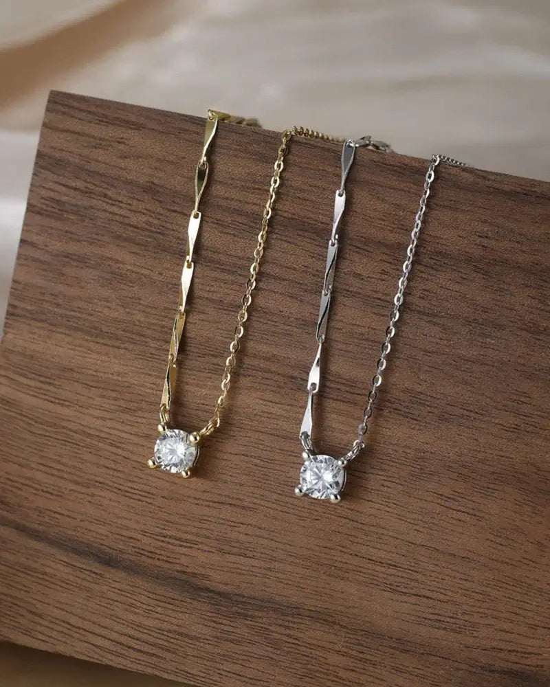 Bling pendant necklace featuring dazzling cubic zirconia on gold and silver cable chains showcasing elegance.