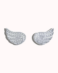 Pair of silver wing-shaped earrings with clear gemstones on a white background