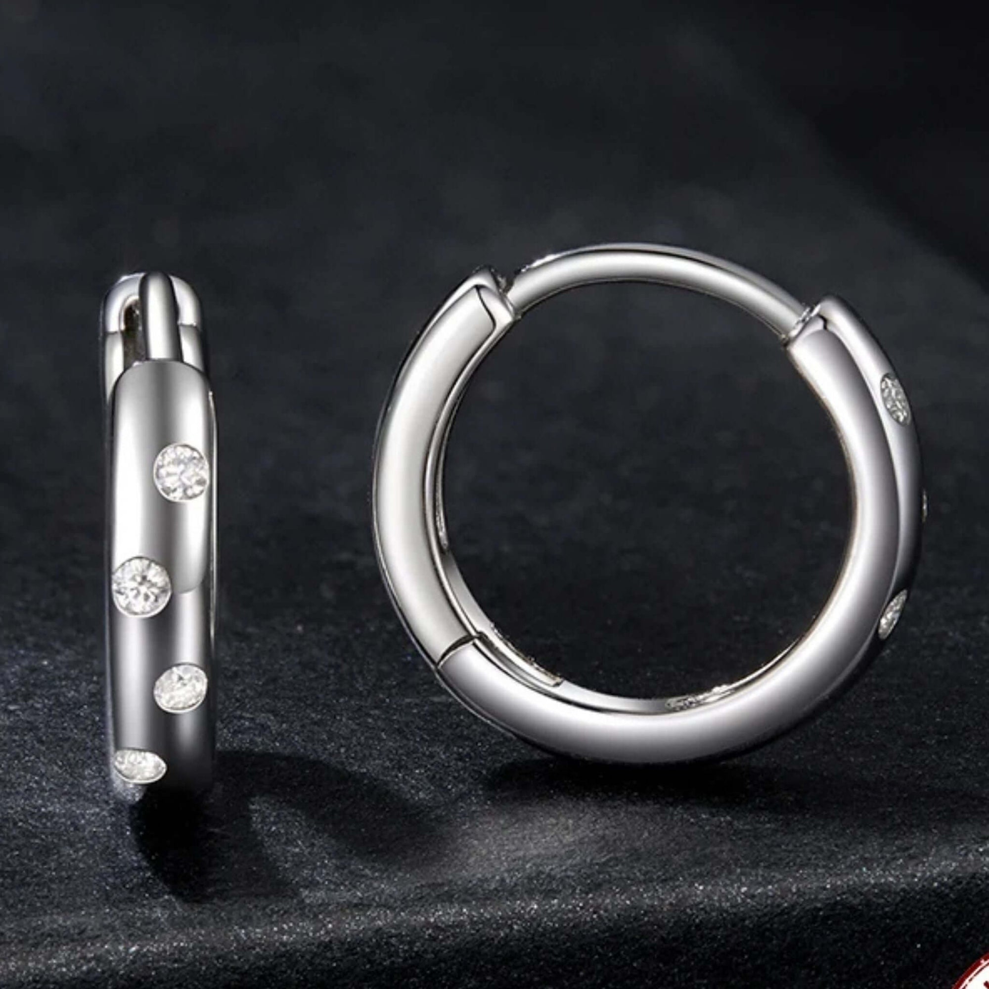 Elegant 0.05 Ct Moissanite Huggie Hoops in white gold, showcasing a polished design with sparkling details.