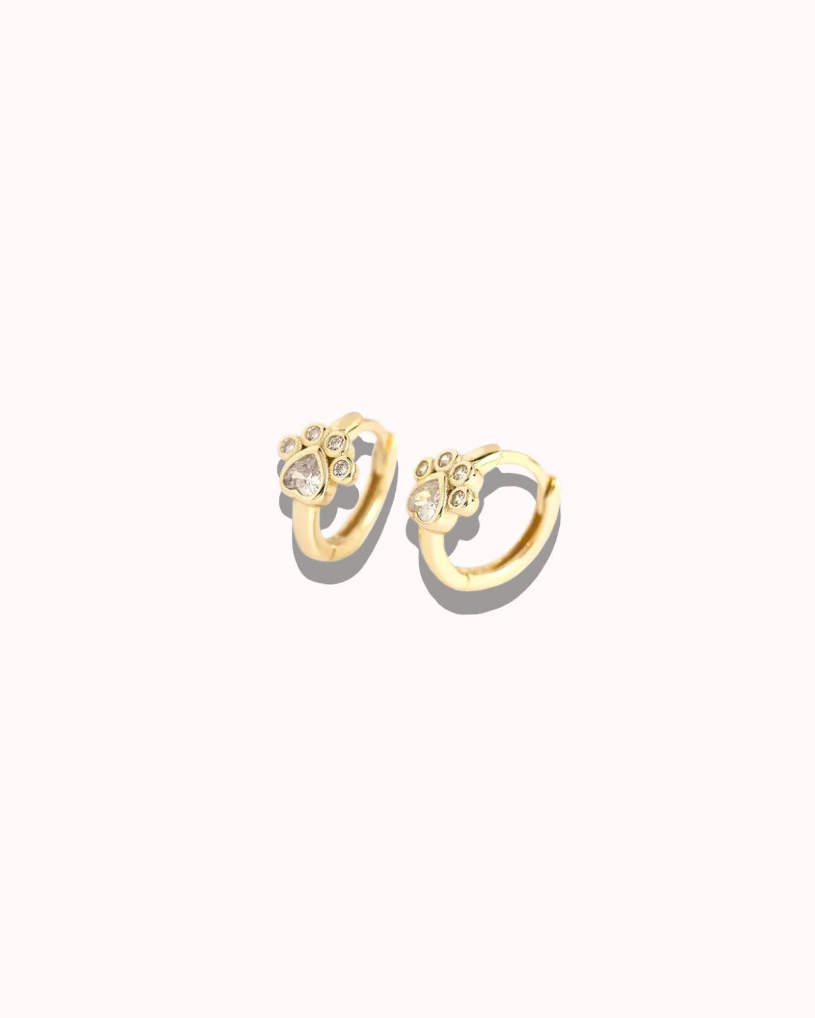Pair of gold hoop earrings with small diamond-like stones on a white background