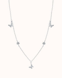 Silver necklace with butterfly pendants on a white background