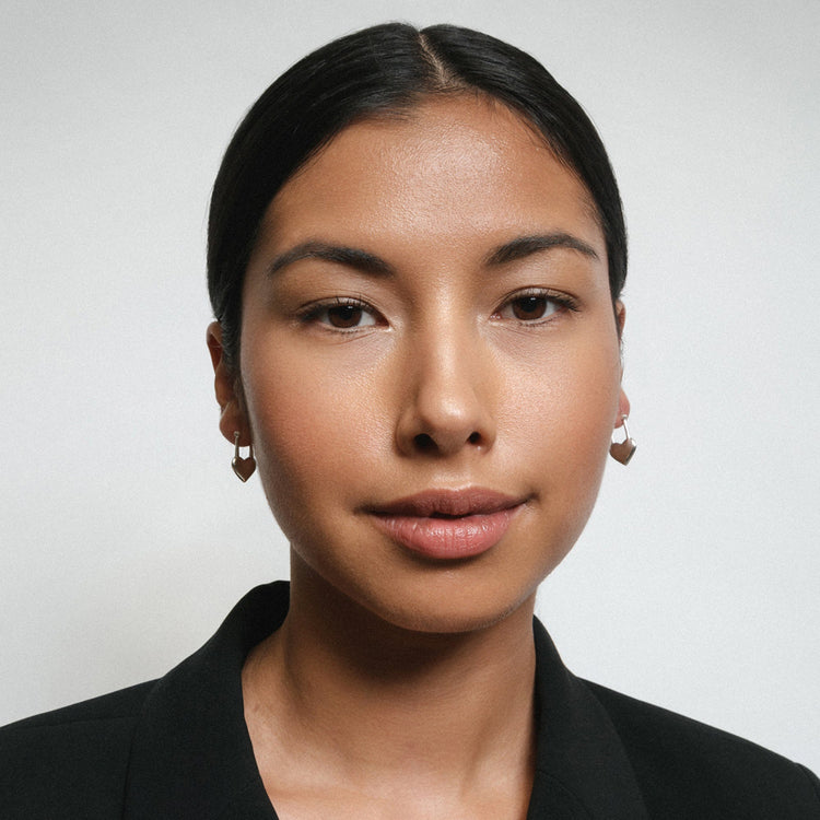 A women wearing a beautiful silver coloured heart lock earring