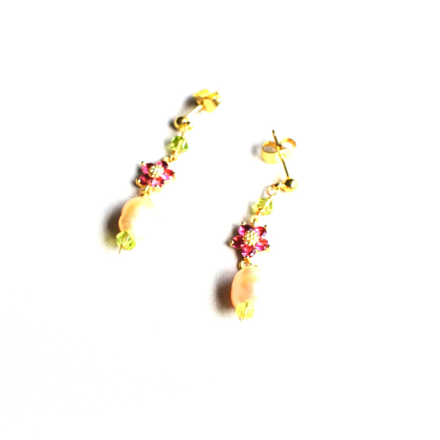 A beautiful drop earring made of peach baroque pearl, tiny peridot beads and red zirconia flower connector 