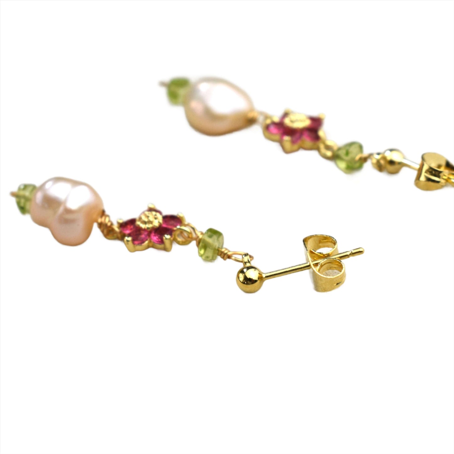 Pearl and peridot earring made of 14k gold filled is shown against a white background