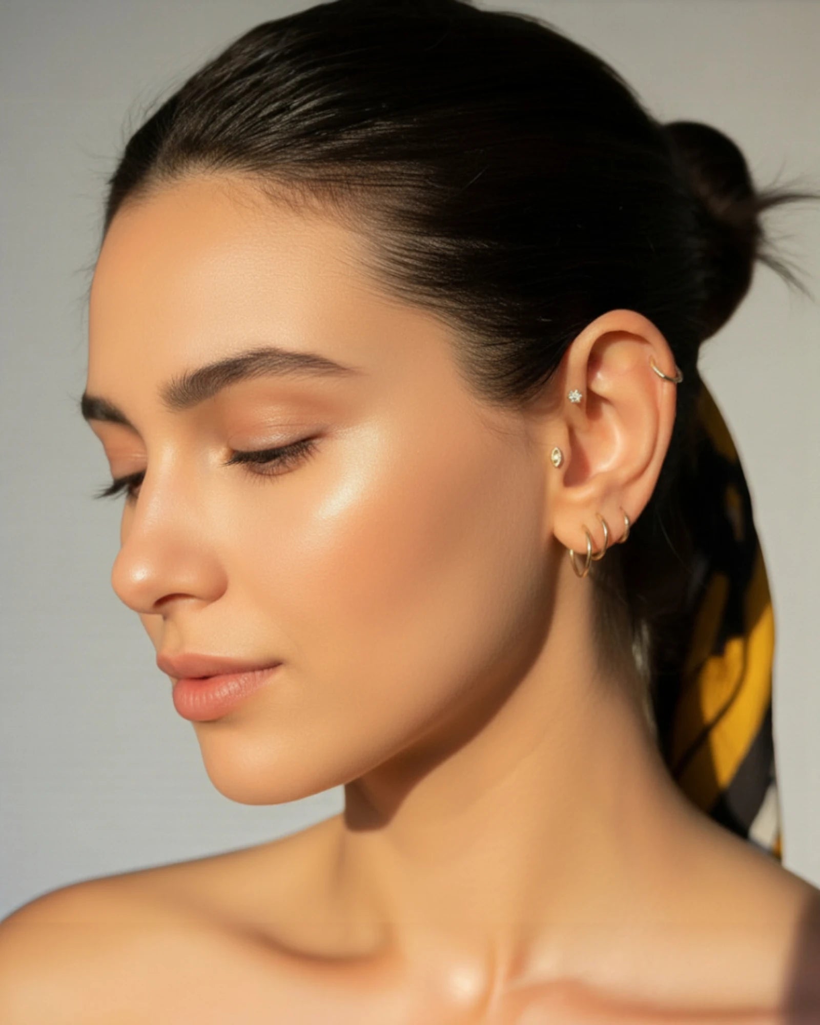 Model showcasing the Single Piece Evil Eye Flat Back Cartilage Stud in a stylish ear arrangement.