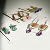 Beautiful gemstone earrings are displayed.