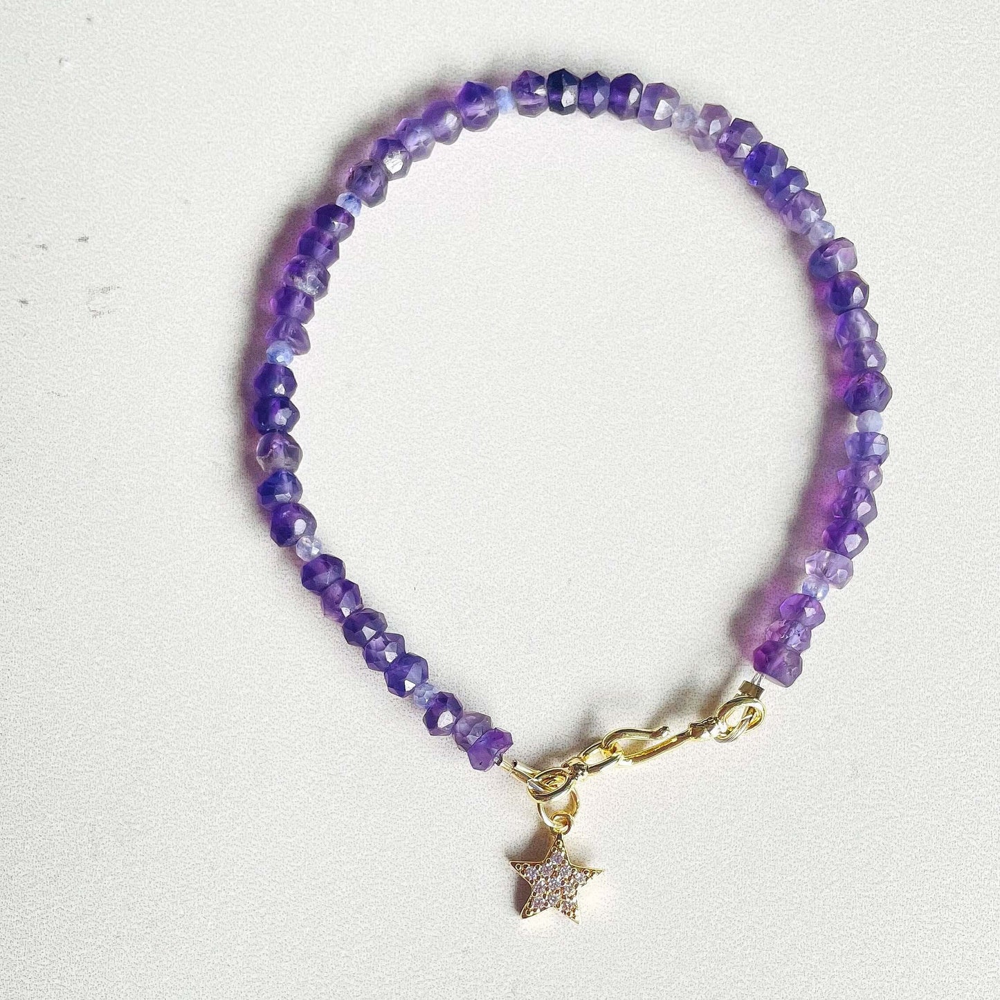 Picture of a dainty purple amethyst bracelet with star charm 