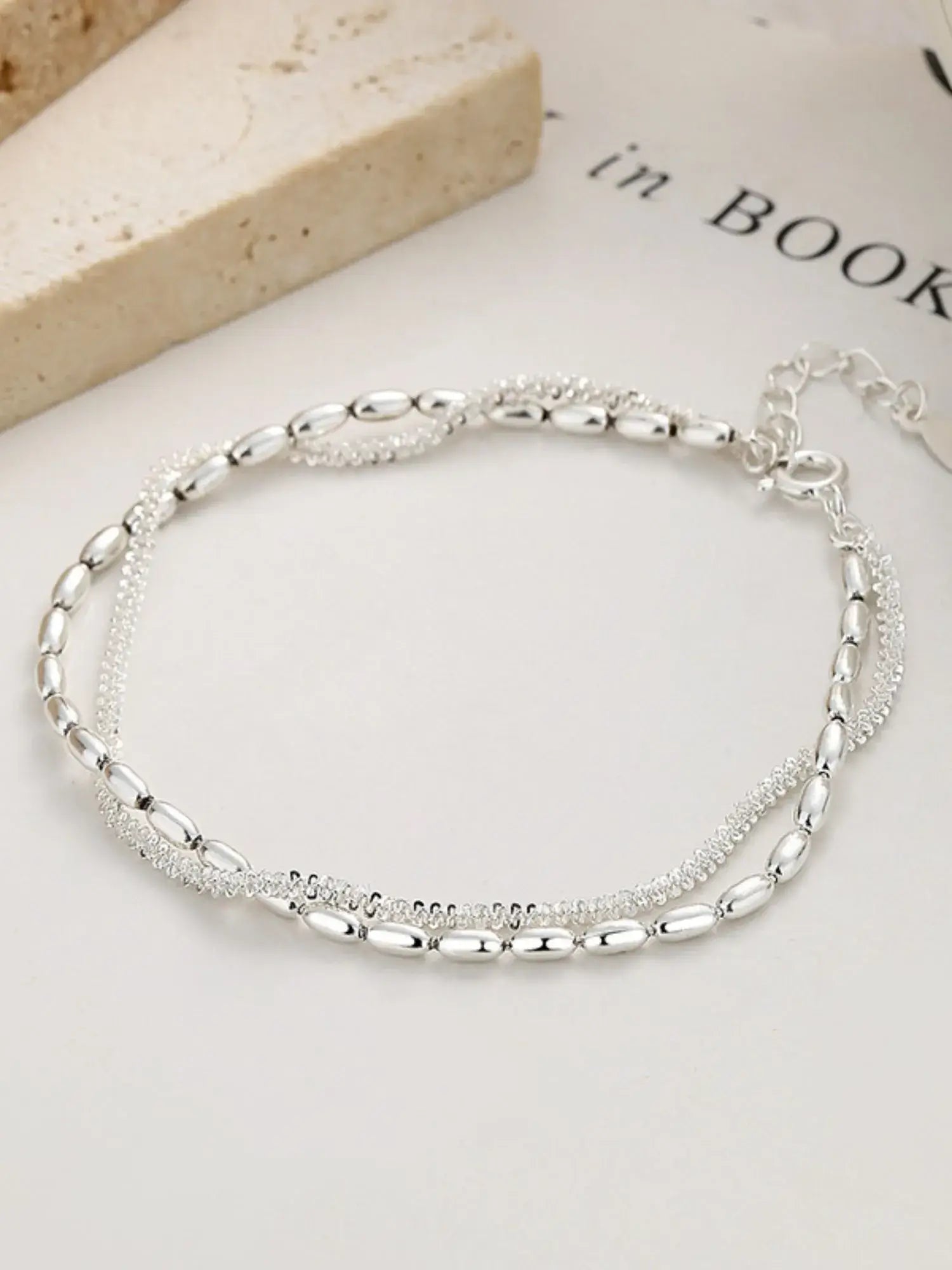 Silver bracelet on a light background