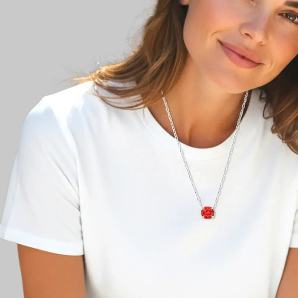 Woman wearing a red zircon pendant necklace, showcasing the octagonal rose cut stone on a silver chain.