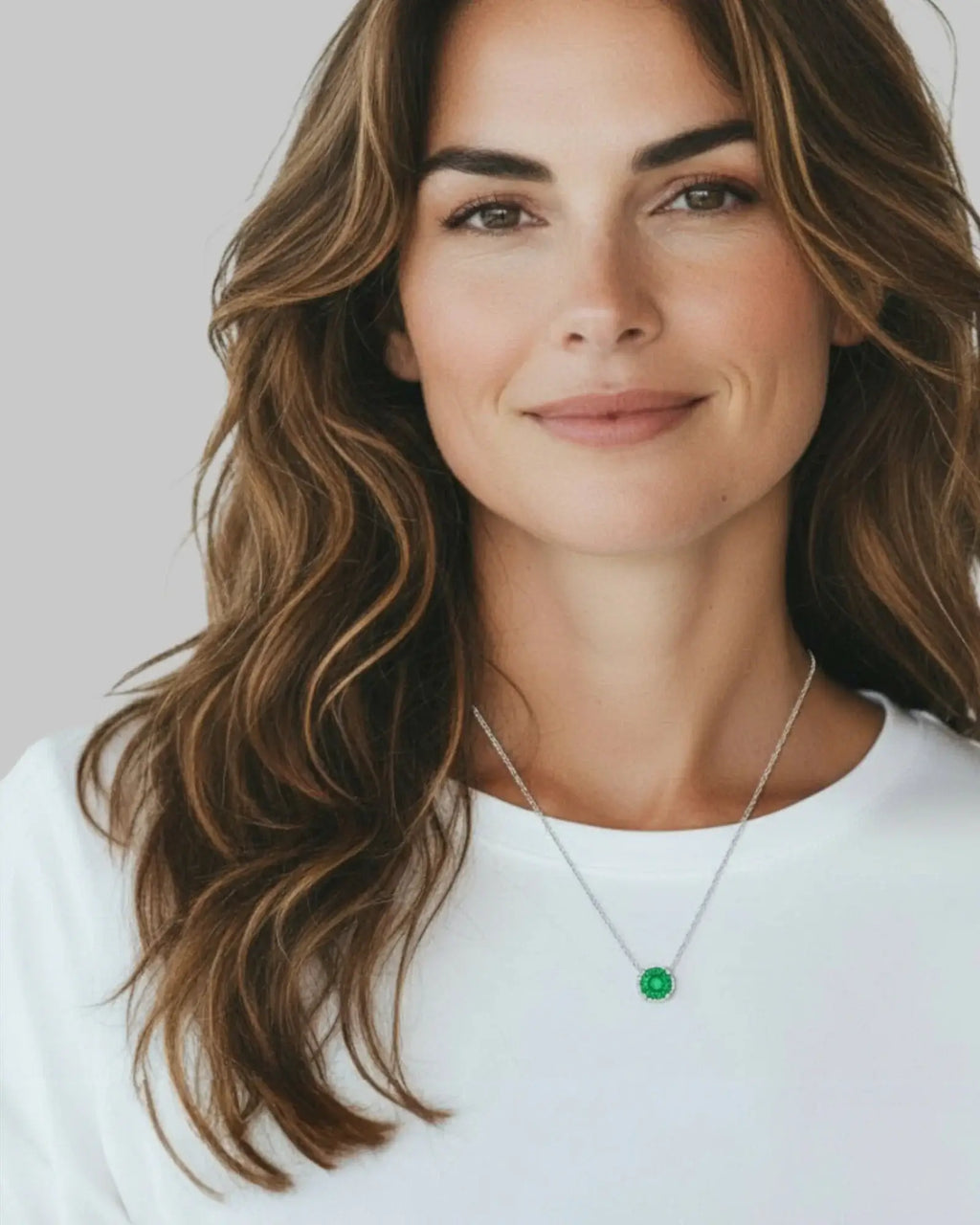 Woman wearing a green zircon pendant necklace, showcasing its octagonal rose cut design in silver.
