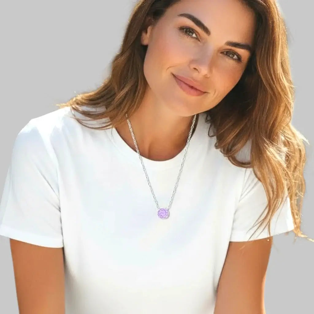 Woman wearing a lavender zircon pendant necklace in silver, showcasing its beauty and elegance.