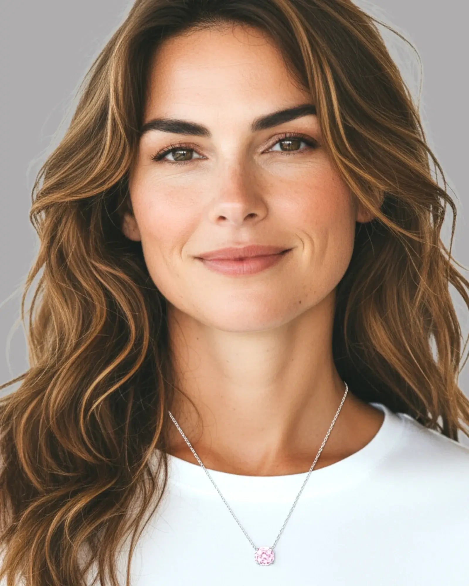 Model wearing an octagonal rose cut pink zircon pendant necklace in silver, showcasing the elegant design.