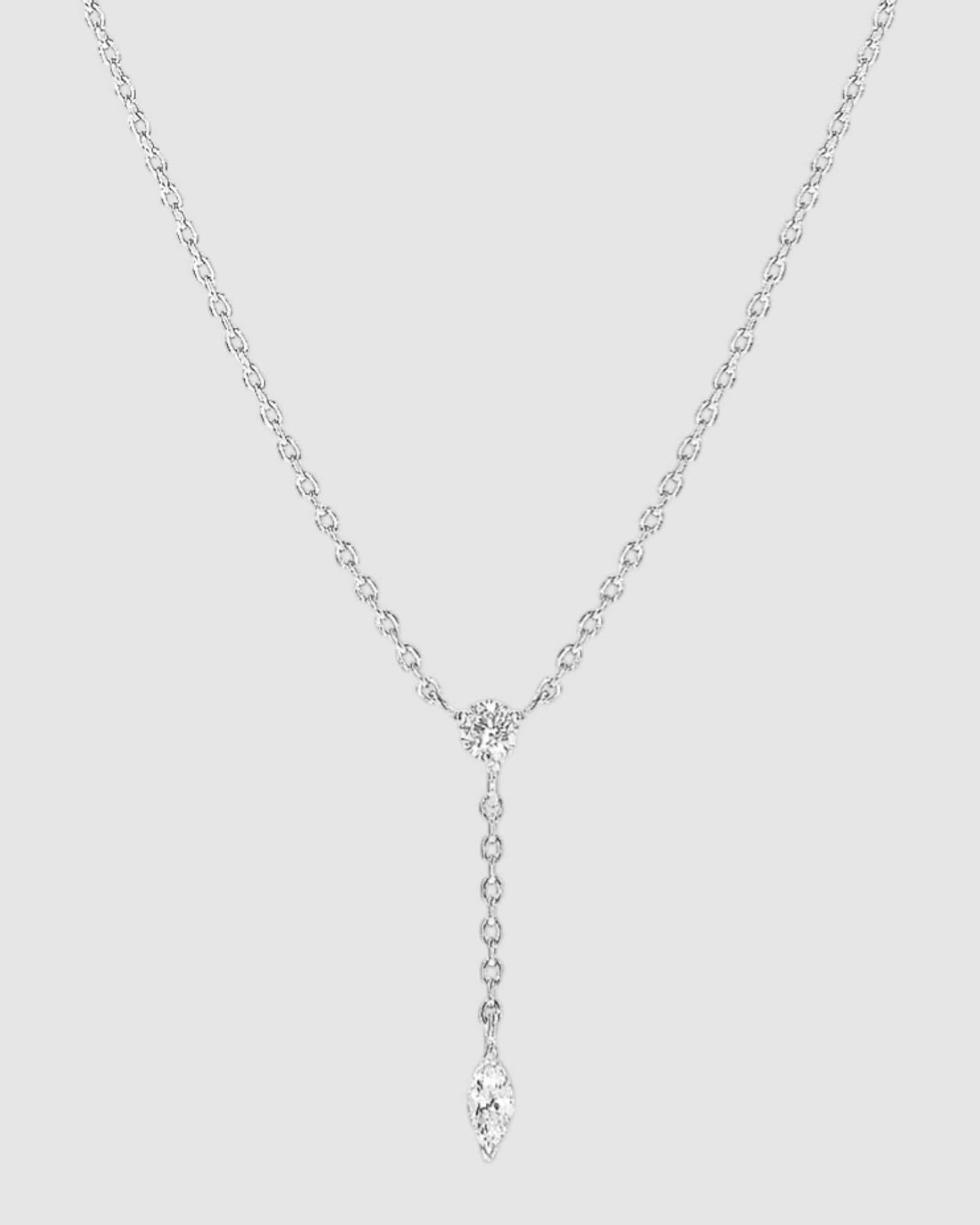 Radiant Lariat necklace featuring adjustable cable chain, brilliant cut zirconia and marquise cut stone for versatile elegance.
