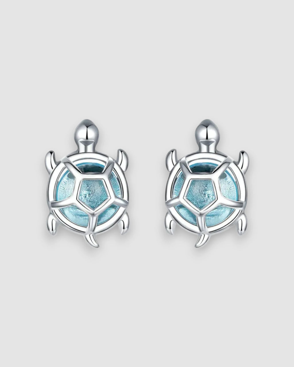 Sea Turtles Stud Earrings in Silver with blue glass stones and platinum-plated settings.