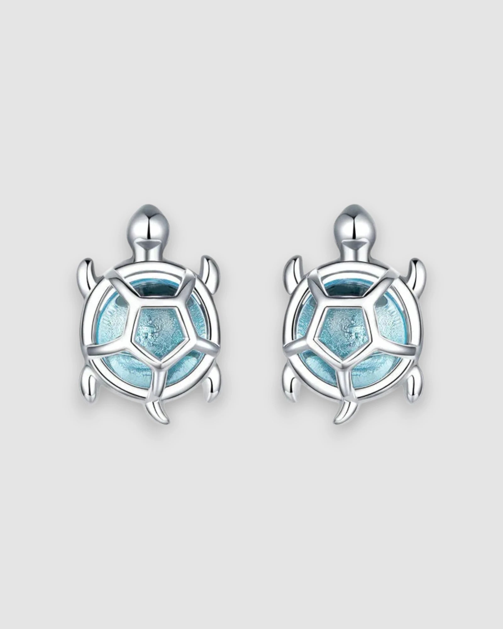 Sea Turtles Stud Earrings in Silver with blue glass stones and platinum-plated settings.