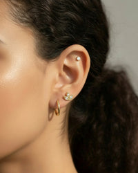 Model wearing a Single Piece Three leaf Flat Back Cartilage Stud in gold, showcasing elegant ear styling.