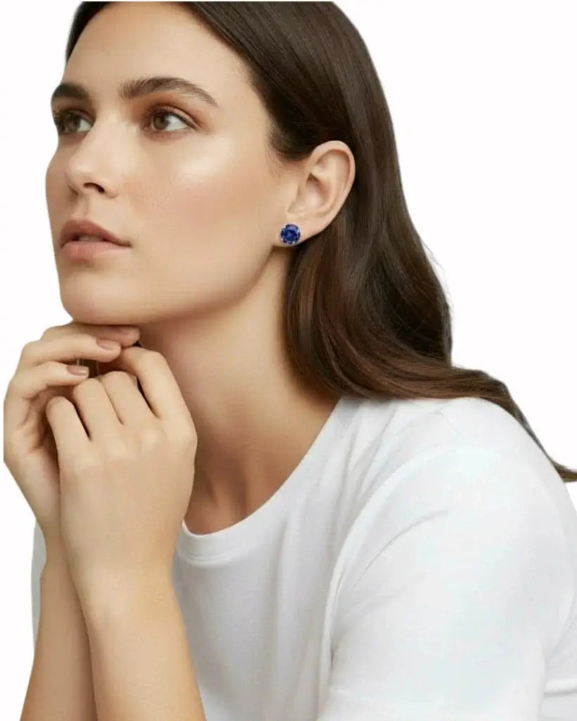 Woman wearing a blue earring on a white background