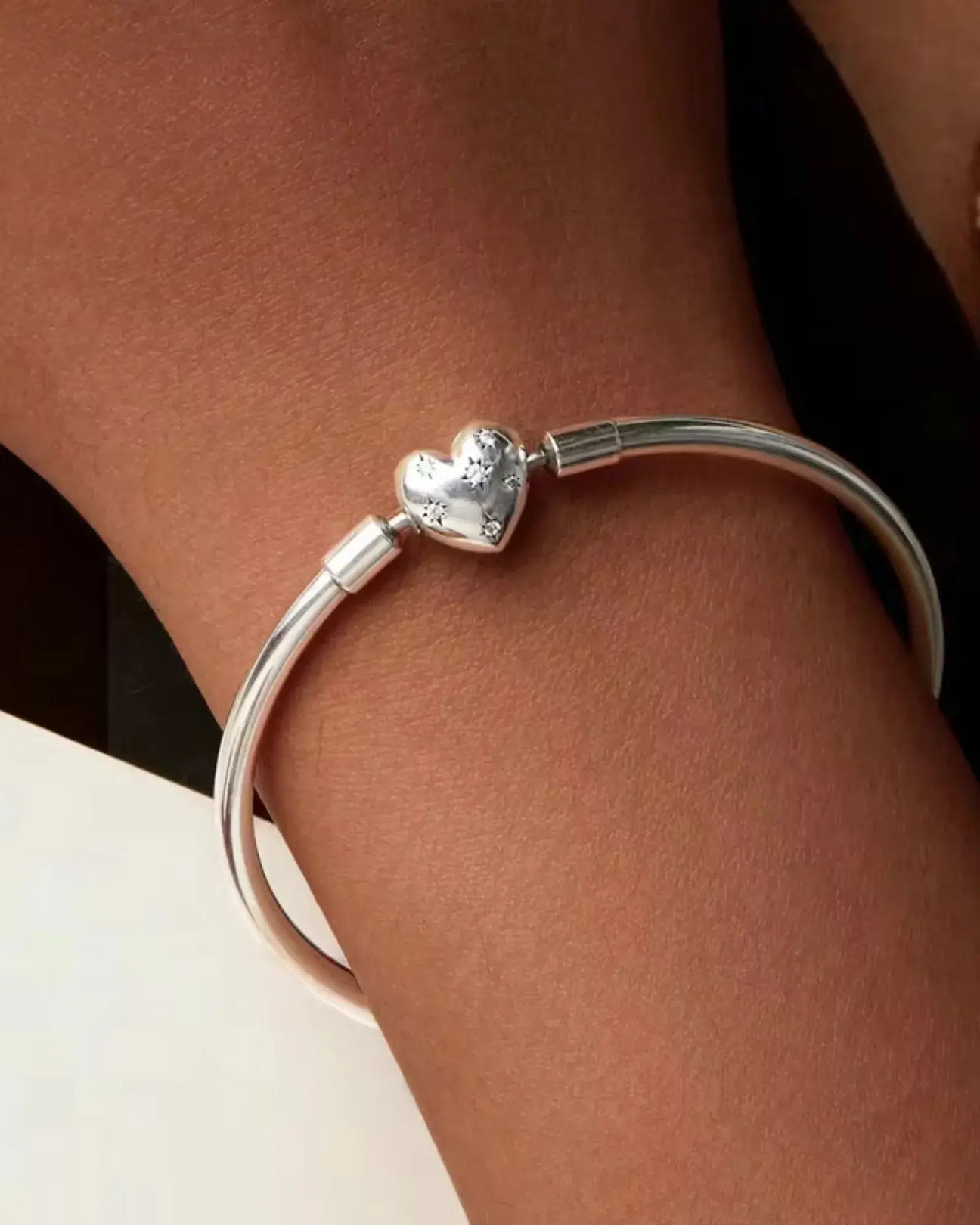 Close-up of the Deep Love Bangle Bracelet crafted in 925 Sterling silver with a heart centerpiece, perfect for stacking.