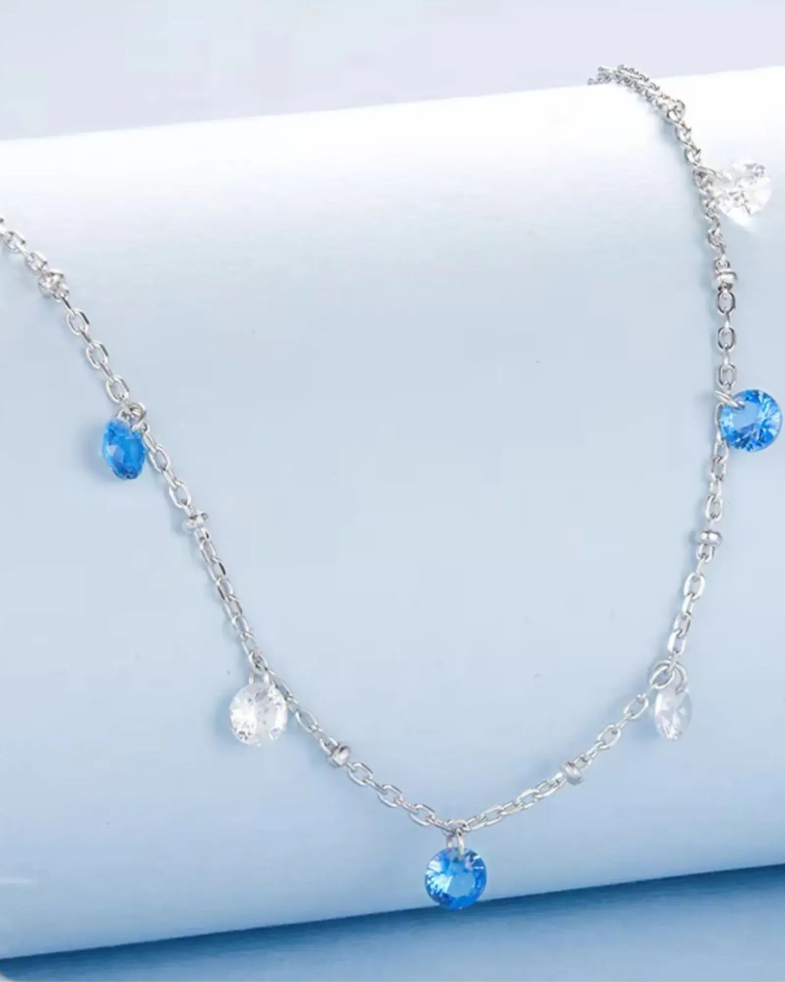 Elegant silver necklace featuring blue and clear zircon stones, perfect for layering and adding sophistication to any outfit.