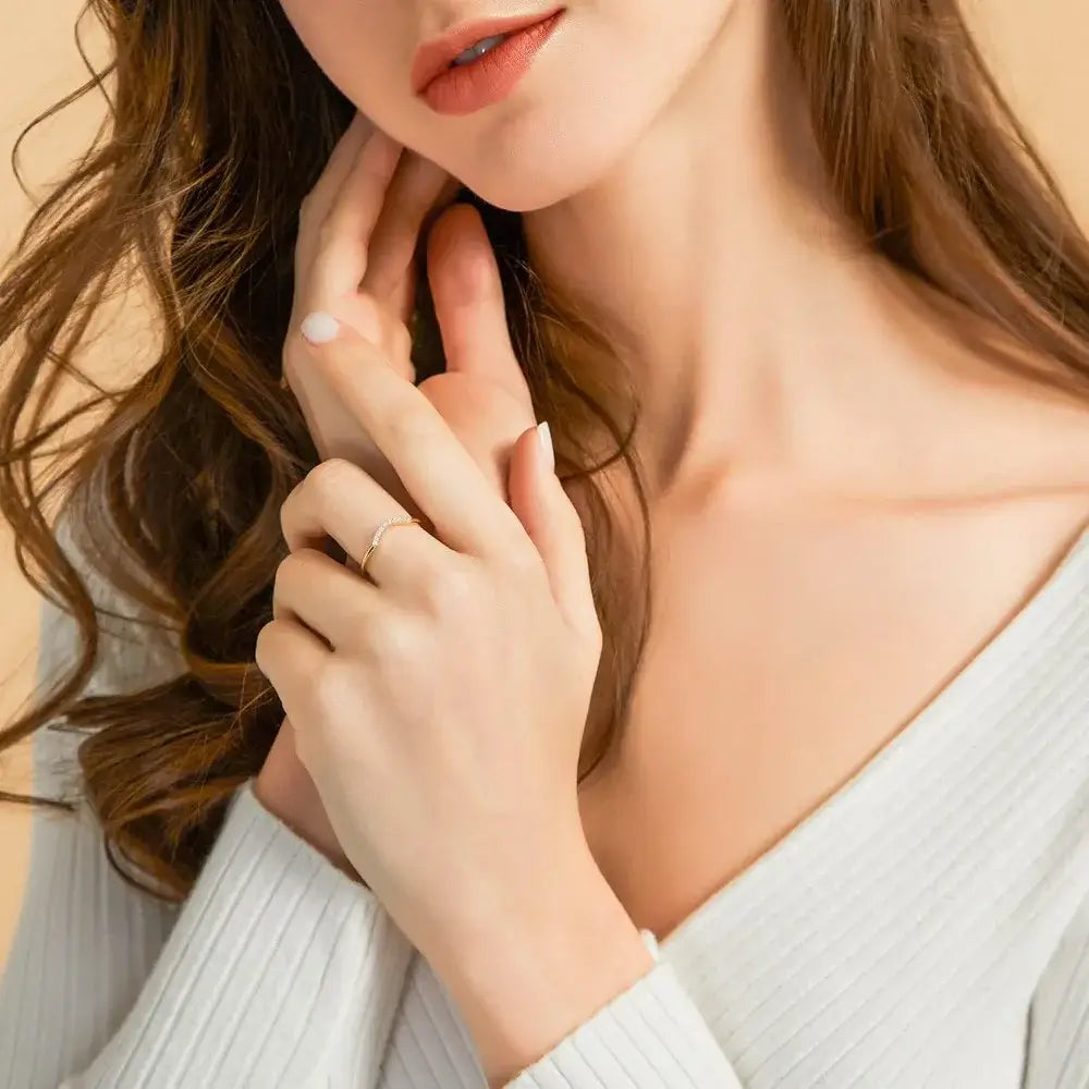 Close-up of a woman wearing the Aurum Arc Ring, showcasing its elegant design and radiant cubic zirconia.