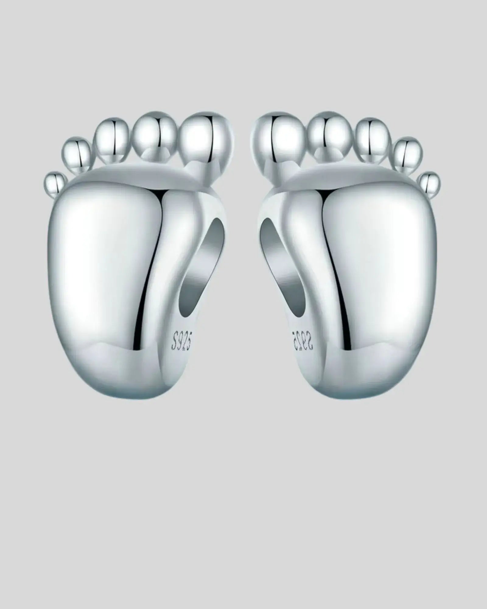 Engravable sterling silver baby feet charm, perfect for personalized jewelry to celebrate special moments.