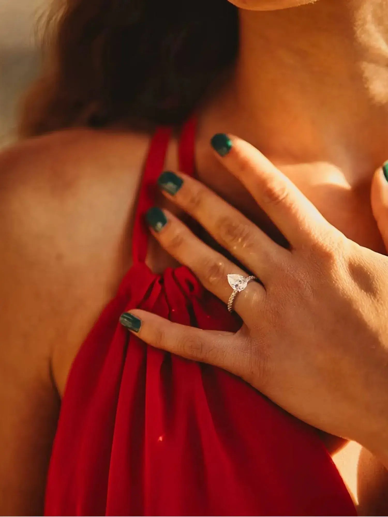 Woman wearing a Golden Promise Engagement Ring with a water drop cubic zirconia, showcasing elegance and style.