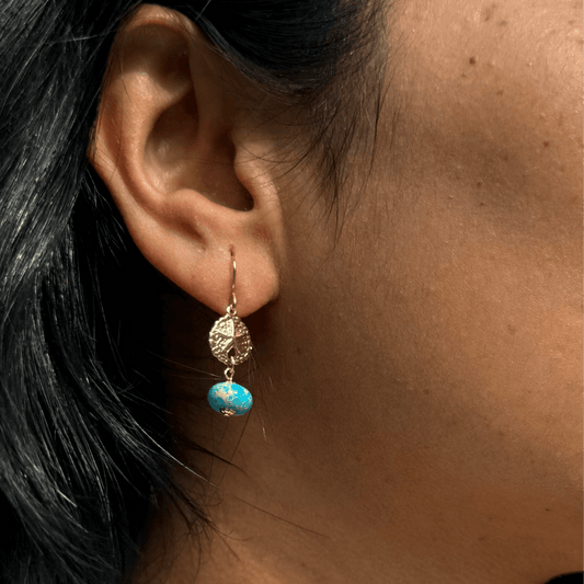 a woman wearing a beautiful Arizona turquoise earring in gold filled