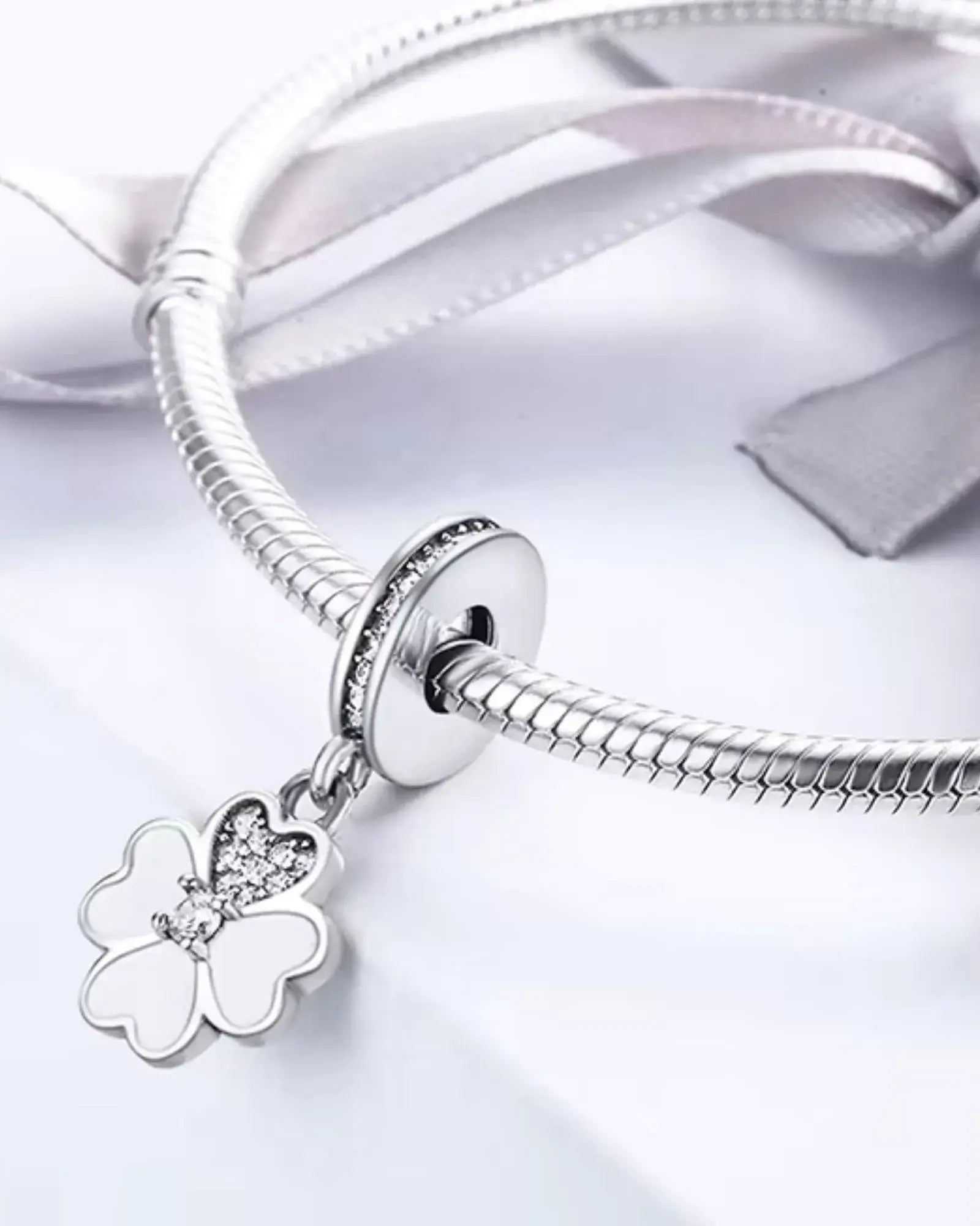 Heart Petals Clover Dangle Charm on a bracelet, crafted from 925 sterling silver with a stylish clover design.