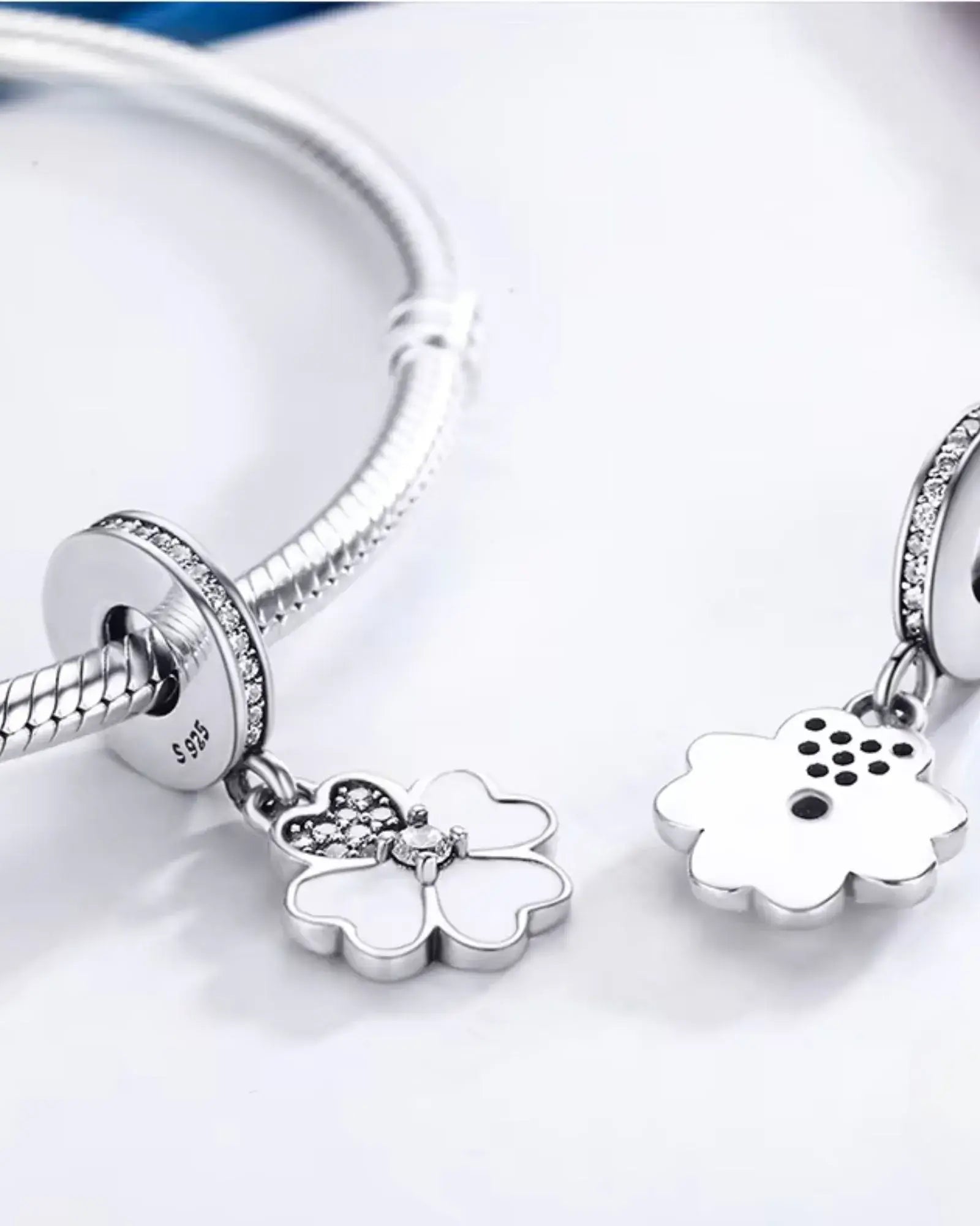 Elegant Heart Petals Clover Dangle Charm showcasing intricate clover design in 925 sterling silver with platinum plating.