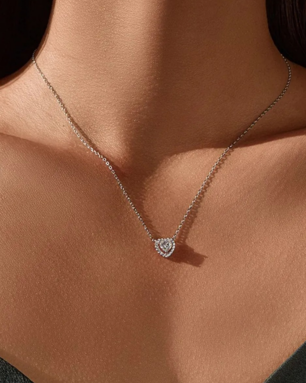 0.5 Ct Hollow heart Moissanite necklace elegantly displayed on a model, showcasing its stunning design and brilliance.