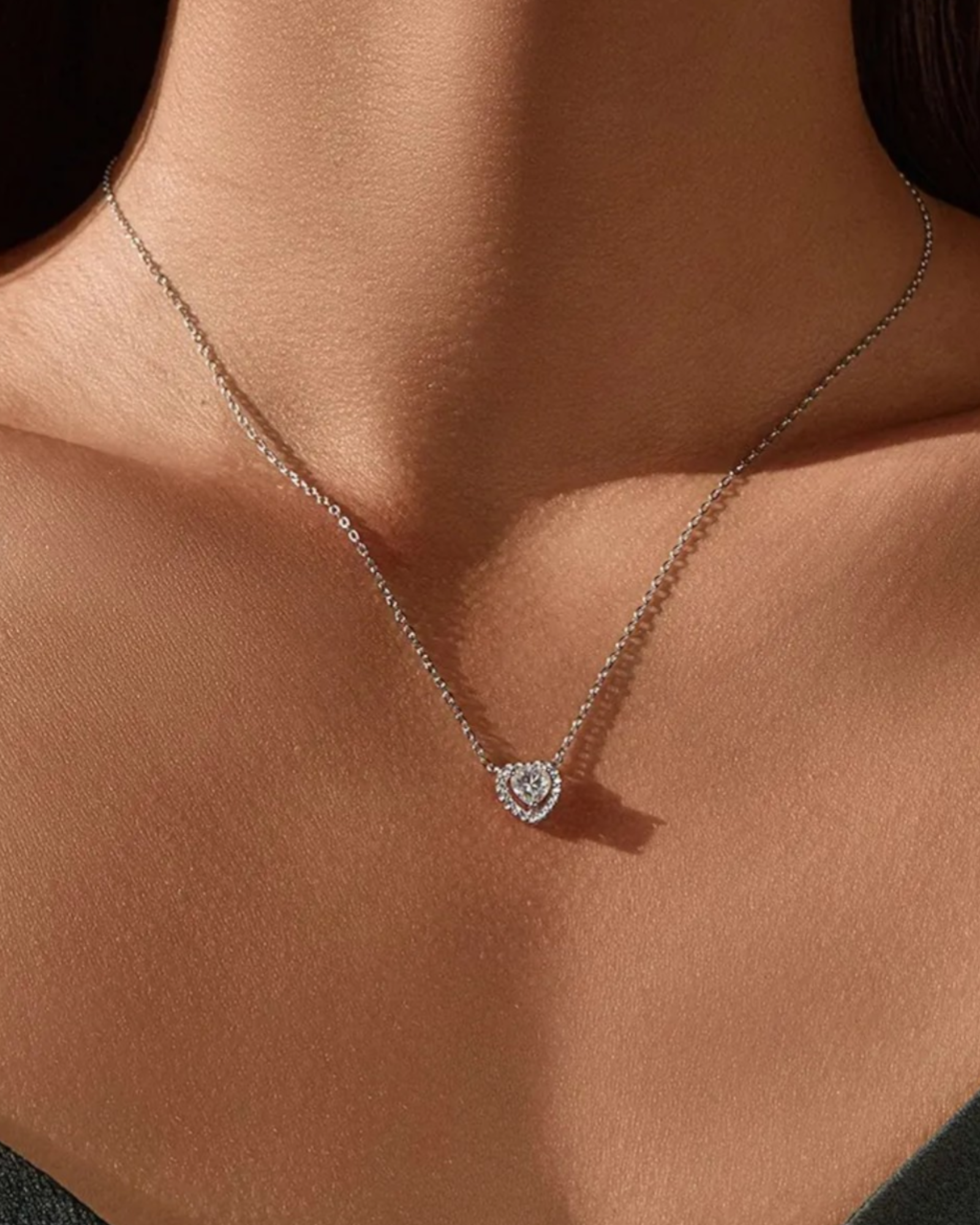 0.5 Ct Hollow heart Moissanite necklace elegantly displayed on a model, showcasing its stunning design and brilliance.