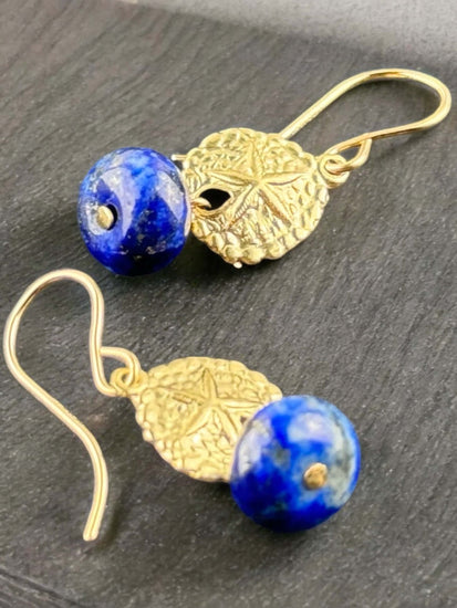 close up look of a natural lapis lazuli earring featuring San dollar symbol