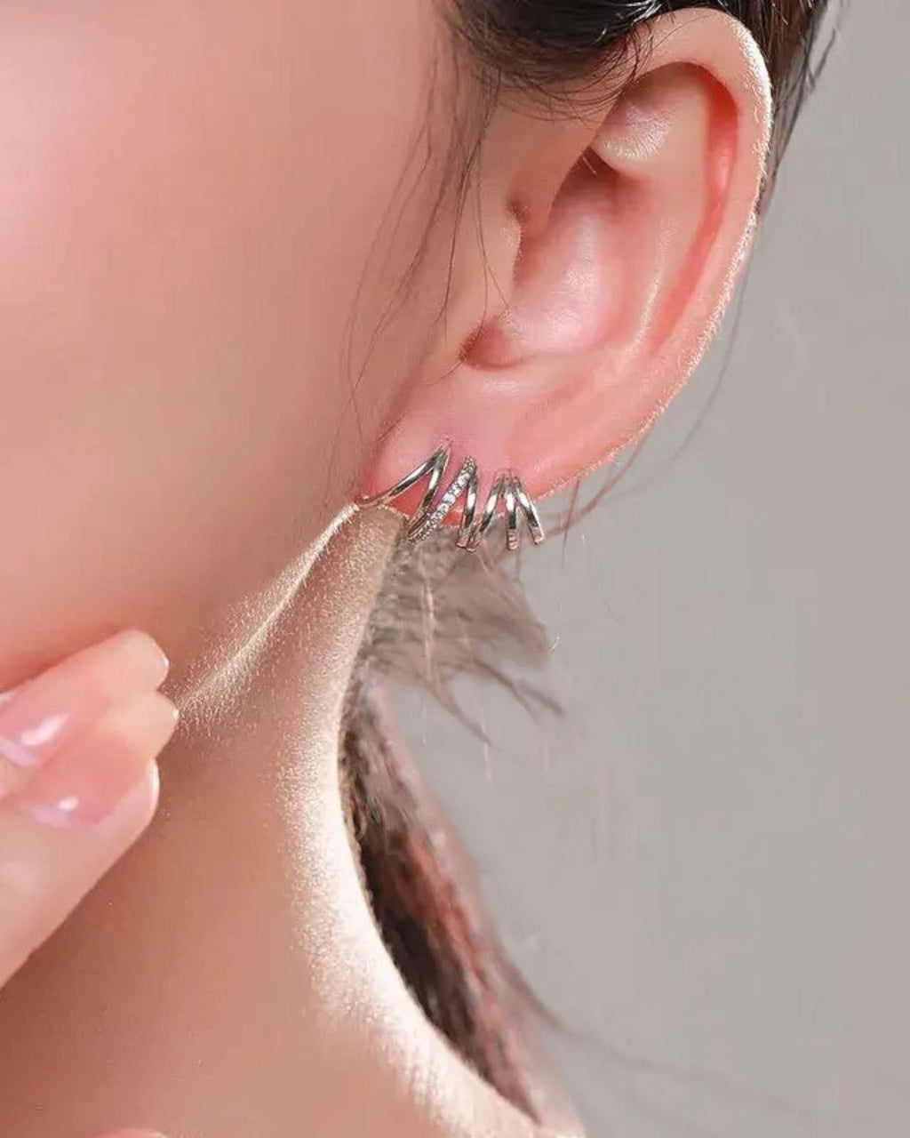 Pearlstones Zircon Line Ear Studs, 925 sterling silver with white gold plating, featuring a layered spiral design with small cubic zirconia stones.