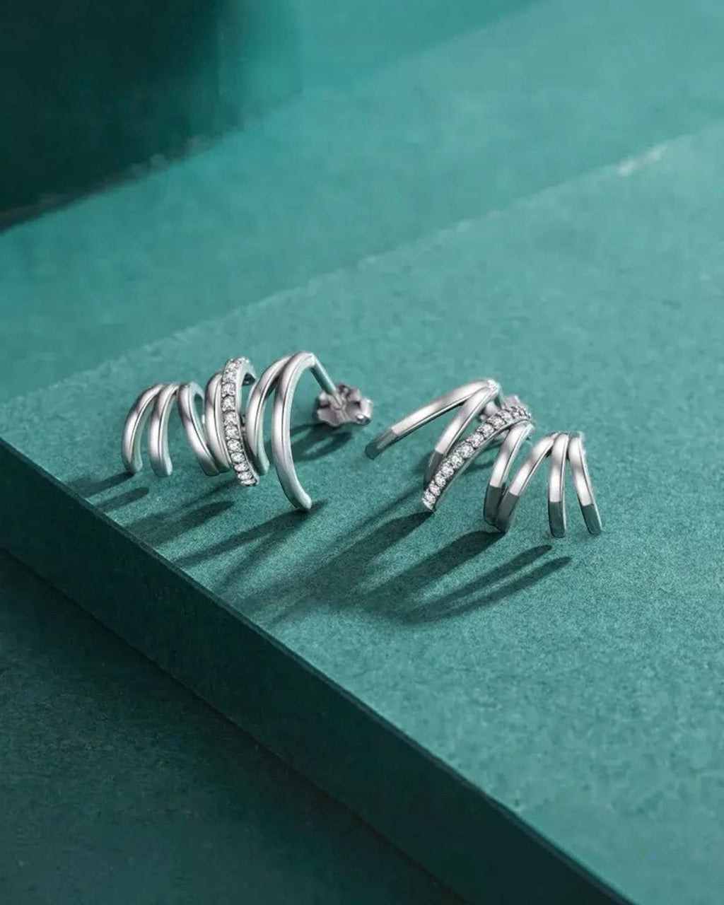 Pearlstones Zircon Line Ear Studs, 925 sterling silver with white gold plating, featuring a spiral design with small cubic zirconia stones.