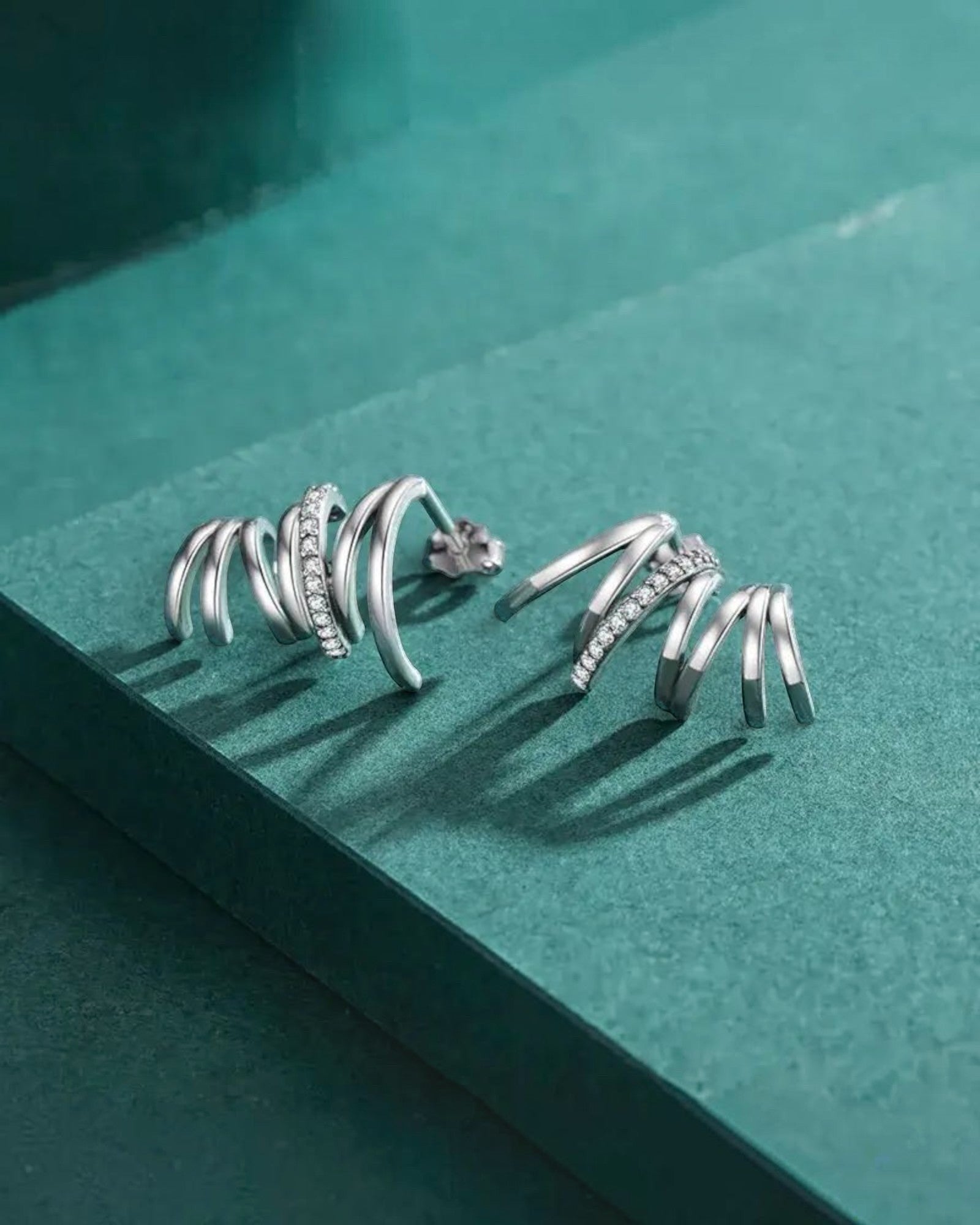 Pearlstones Zircon Line Ear Studs, 925 sterling silver with white gold plating, featuring a spiral design with small cubic zirconia stones.