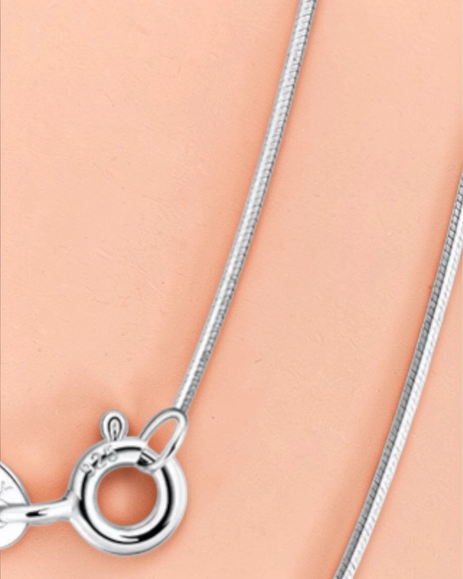 0.8mm Sided Snake chain featuring a secure clasp and sleek design on a soft background.
