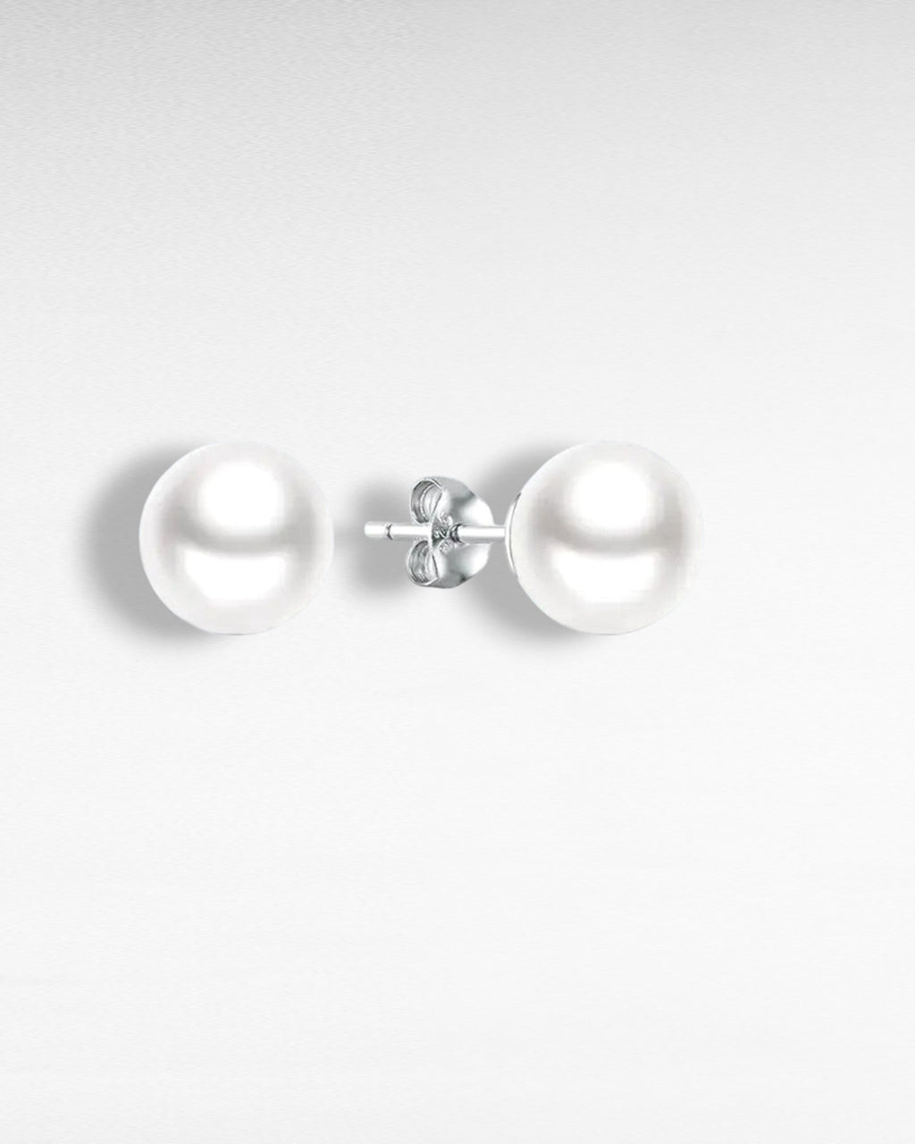 Pearlystones Aluna pearl stud earrings in 925 sterling silver with white gold finish. Classic freshwater pearl design.