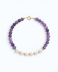 Pearlystones beaded bracelet featuring purple amethyst gemstones and white pearls with gold-toned spacers.