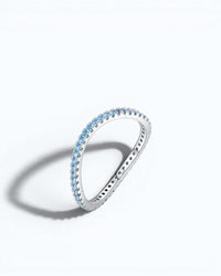 Pearlystones Azure Glow sterling silver eternity band featuring a row of vibrant blue zircon stones.