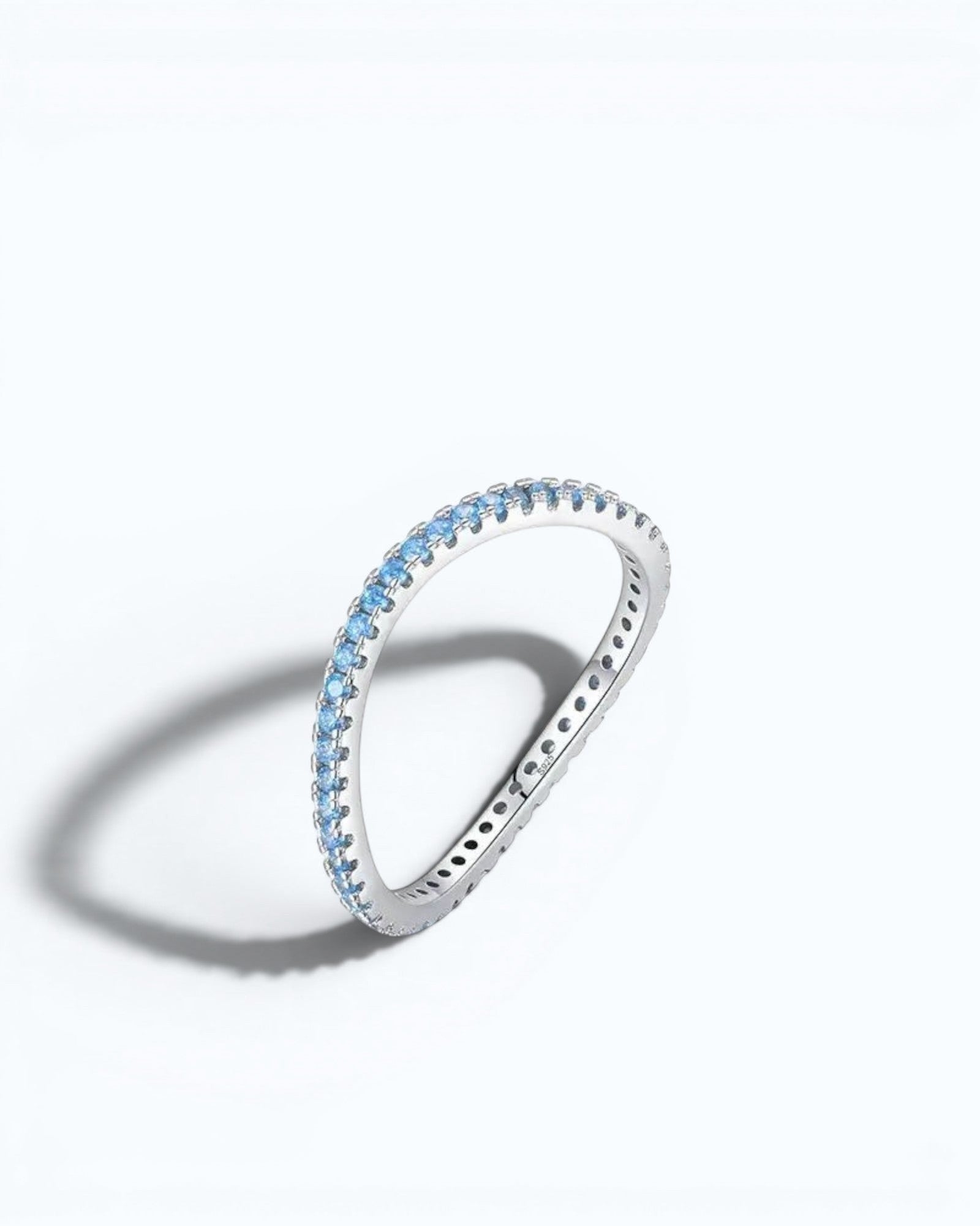 Pearlystones Azure Glow sterling silver eternity band featuring a row of vibrant blue zircon stones.